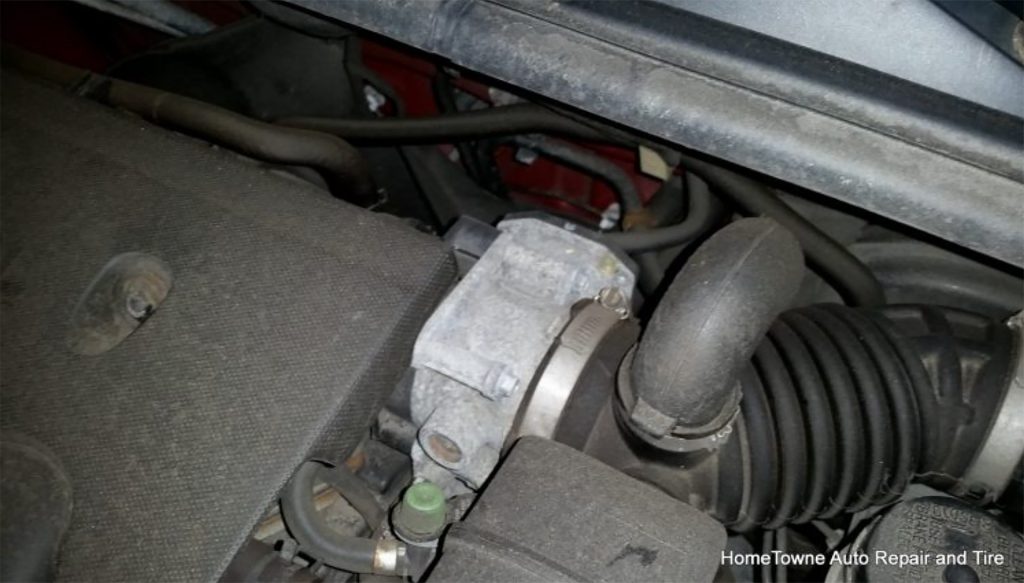 Nissan Sentra throttle body with EVAP test port and intake boot.