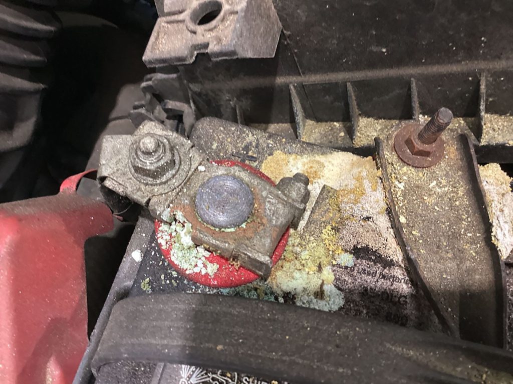 Corrosion buildup on a Toyota Corolla battery.