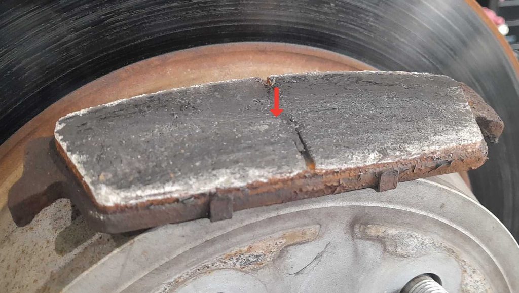 Burnt brake pads and rotors on a GMC Sierra.