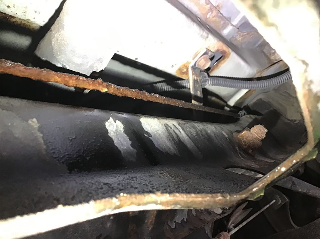 A brake line leaking on a Chevrolet Impala.