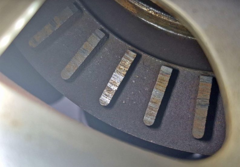 Brake rotor worn off and venting fins exposed.